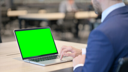 Businessman Working on Laptop with Green Chroma Screen 