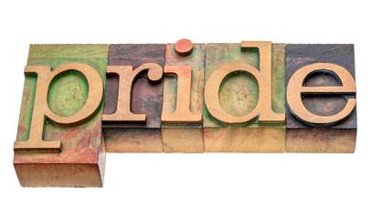 pride isolated word abstract in letterpress wood type stained by color inks