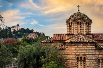 Athens, Greece. Old Byzantine church located at the archaeological site of Agora of Athens in Thiseio district. In the background is the old National Observatory of Athens ontop of the Nymphs' Hill
