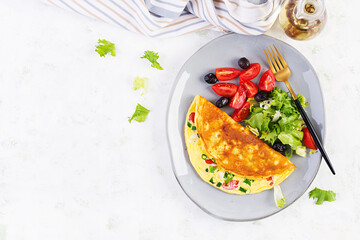 Keto breakfast. Omelette with cheese, tomatoes and green onions on light table. Italian frittata. Keto, ketogenic lunch. Top view, overhead, copy space