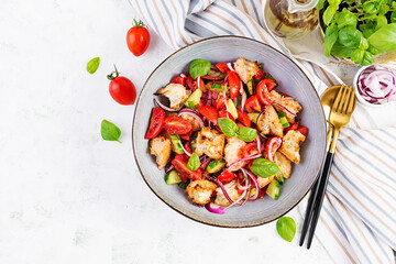 Tuscan Panzanella, traditional Italian salad with tomatoes and bread. Vegetarian panzanella salad. Mediterranean healthy food. Top view, copy space