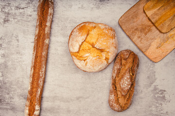 Artisan bread with wheat cereals on a stone table