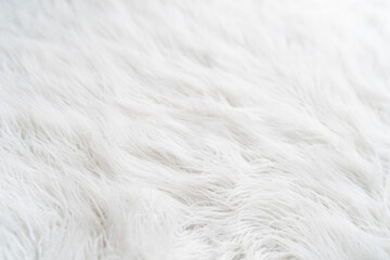 Textured white background with hairy fur carpet, close-up
