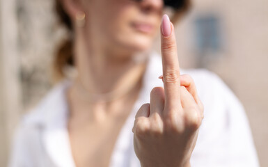 Offended woman showing middle finger