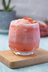 Tomato juice blended with sweet syrup in a clear glass