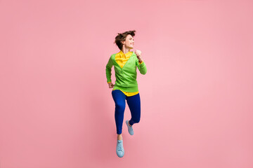 Full size photo of young crazy girl happy positive smile hurry run jump up look empty space isolated over pastel color background