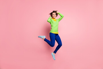 Fototapeta na wymiar Full size photo of young active girl happy positive smile have fun crazy jump up isolated over pastel color background