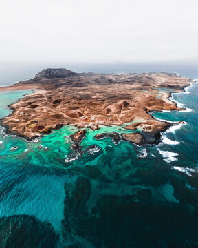 Aerial view of wild rock formation at shoreline in Isla de Lobos, Canary Islands, Spain.
