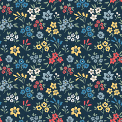 Seamless floral pattern. Ditsy background of small colorful flowers. Small flowers scattered over a navy blue background. Stock vector for printing on surfaces and web design.