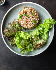 buckwheat and salad fresh green mix salad lettuce trend diet meal snack copy space food background rustic. top view keto or paleo diet vegan or vegetarian food