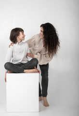 boy 10 years old and mother on a white background in the studio