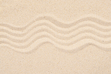 Fototapeta na wymiar Sandy texture or background, top view of tropical sand with abstract pattern, lines on the sand.