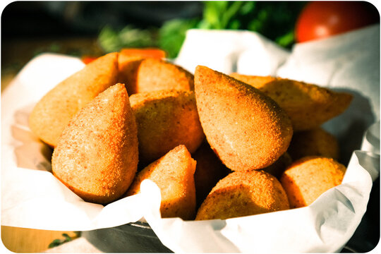 A tempting close-up of coxinha de frango, a classic Brazilian savory snack, beautifully arranged on a serving plate.  This iconic Brazilian comfort food.