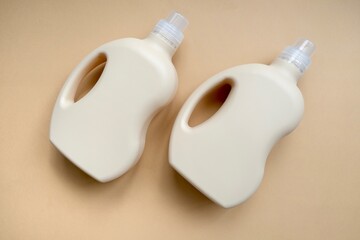 Laundry detergents (gel and conditioner) on beige background. Laundry and cleaning kit. The concept of cleanliness. Two Bottle of detergent on beige background.