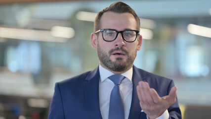 Portrait of Middle Aged Businessman Feeling Shocked 