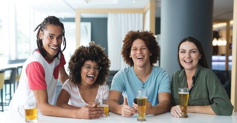 Portrait of group of male and female friends smiling at bar