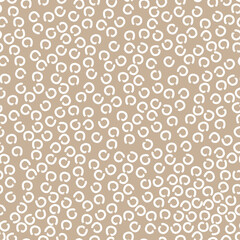 doodle abstract seamless pattern irregular chaotic white circles on contrasting beige background