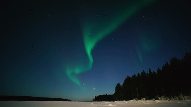 Northern Lights Time lapse 4K video, polar light or Aurora Borealis in the dark winter night sky over the arctic landscape.