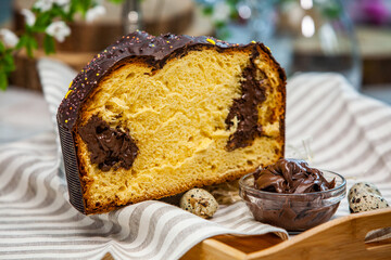 Panettone is the traditional Italian dessert for easter in 2021. Homemade panettone covered in chocolate and sprinkles. Bread served as dessert.