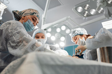 Team surgeon at work in operating room.