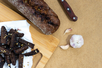 Black bread croutons with garlic and salt. Appetizer of black garlic bread.