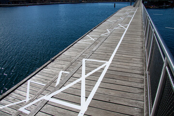Squares painted in white on boardwalk by the sea for social distancing to prevent the spread of Coronavirus Covid-19. 
