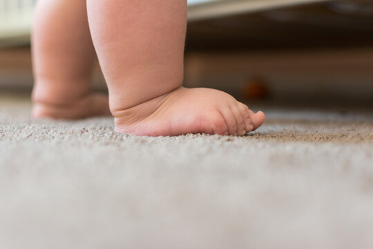Adorably chubby toddler feet and legs; baby learning to walk