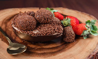 Chocolate Easter Egg filled with brigadeiro (brigadier) and strawberries, Goumert egg chocolate tradition in Brazil.