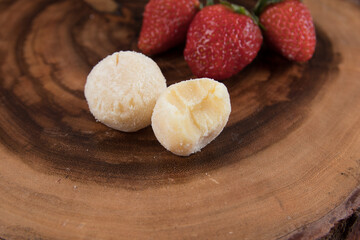 powdered milk brigadeiro (brigadier), typical candy tradition in Brazil. Powdered milk brigadeiro with strawberries