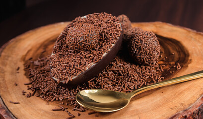 Chocolate Easter Egg filled with brigadeiro (brigadier), Goumert egg chocolate tradition in Brazil. Wood Background