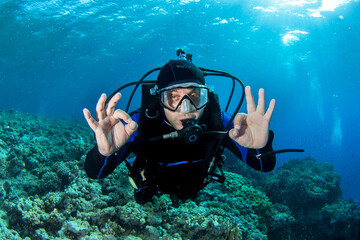 Scuba diver gives OK sign.