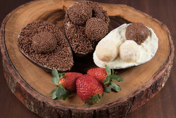 Chocolate Easter Eggs filled with brigadeiro (brigadier), powdered milk and strawberries. Goumert...