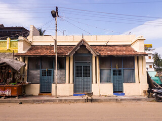 A vintage house with sloping gable roofs on the streets of the town of Rameswaram.