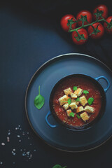 Flat lay and negative space of tomatoes soup  with croutons and basil homemade cooking