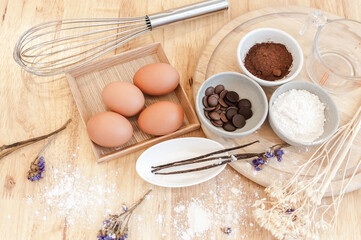 Top View Baking Preparation on wooden Table,Baking ingredients. Bowl, eggs and flour, rolling pin and eggshells on wooden board,Baking concept