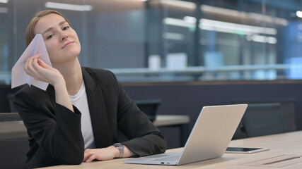 Businesswoman with Laptop Flying Paper Plane 