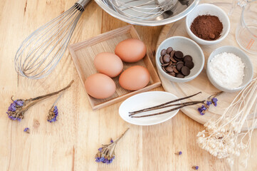 Top View Baking Preparation on wooden Table,Baking ingredients. Bowl, eggs and flour, rolling pin and eggshells on wooden board,Baking concept