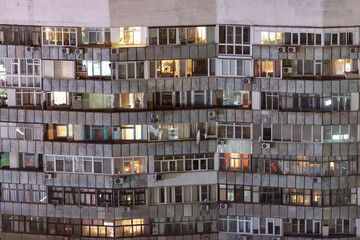 Balconies of an apartment building. Panel construction and miscellaneous glazing. Multi-storey residential building in Krasnodar. Windows and balconies close-up.