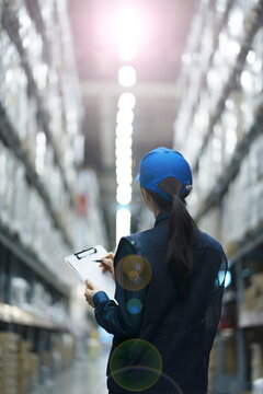 Warehouse Worker Taking Inventory In Logistics Warehouse