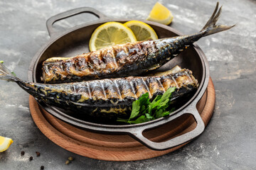 Grilled mackerel fish with lemon herbs and spices, Food recipe background. Close up