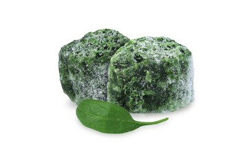 Fresh spinach leaf and frozen spinach cubes on an isolated white background.