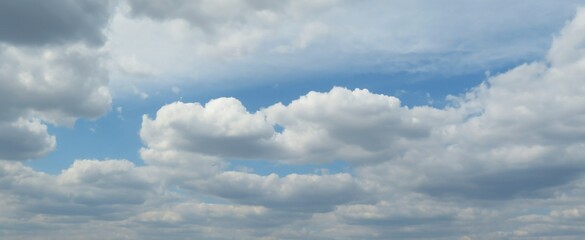 Panoramic view of blue sky with fluffy clouds, natural clouds background