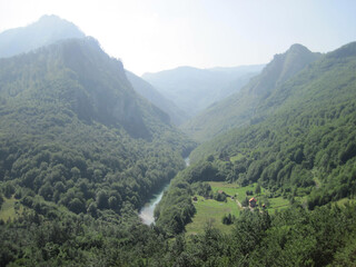 Obraz premium Mountain landscape on a sunny day, wooded hills on the horizon