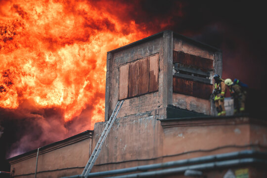 Massive Large Blaze Fire In The City, Brick Factory Building On Fire, Hell Major Fire Explosion Flame Blast,  With Firefighters Team Firemen On Duty, Arson, Burning House Damage Destruction