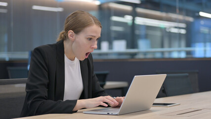 Businesswoman Reacting to Loss While using Laptop 