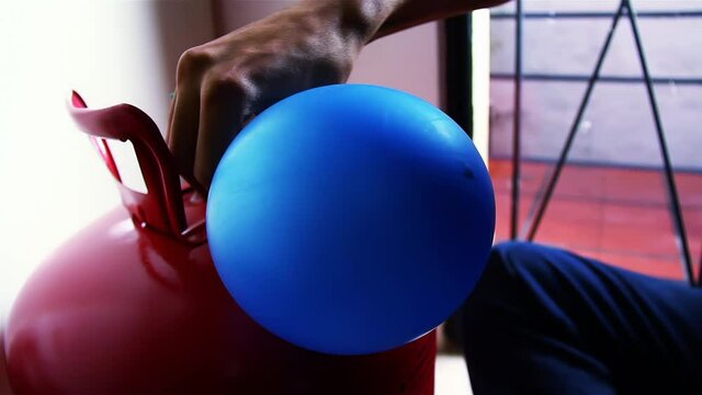 Inflating a Balloon, Helium Tank to fill Party Balloons, Close Up. 4K Resolution.