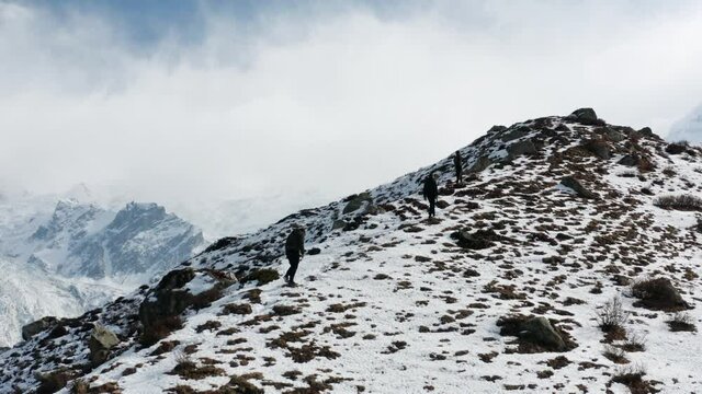 Three Persons On The Way Towards Nanga Parbat's Basecamp In Kashmir, Pakistan - aerial drone shot