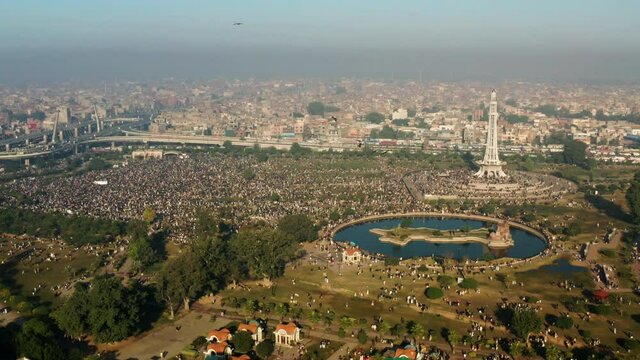 Thousands Of People Gather At Greater Iqbal Park With Minar-e-Pakistan Monument In Lahore, Punjab, Pakistan. - aerial