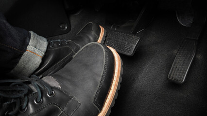Close up the foot pressing foot pedal of a car to drive. Accelerator and brake pedal in a car....