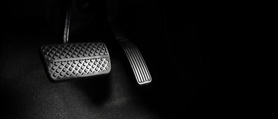 Close up the foot pressing foot pedal of a car to drive. Accelerator and brake pedal in a car....